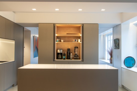 The appliance garage hides all the clutter for the minimalist owners. Two pocket doors in the volume can be closed for separation to the bedroom, or opened for the reading of one larger space. The appliance garage cabinet doors also can fully pocket into the cabinet for ease of use.