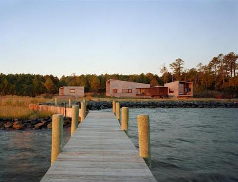 Recessed glass walls create view portals of the salt marsh, pine forest, and river.