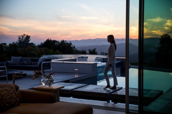 Luxury Beverly Hills home with sliding glass walls that open to the pool terrace and views.