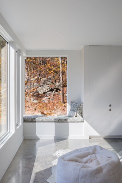 The living room includes a cozy corner window bench for enjoyment by the couple – and just as importantly, their beloved cat. 