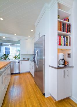 Within easy reach of the kitchen island, narrow bookcases and cabinets make the most of tricky spaces. Location: Austin, Tex. Architect: Stewart Davis. Builder: CG&S Design-Build.