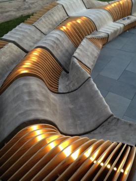 The bench surface is contoured to support multiple seating positions.