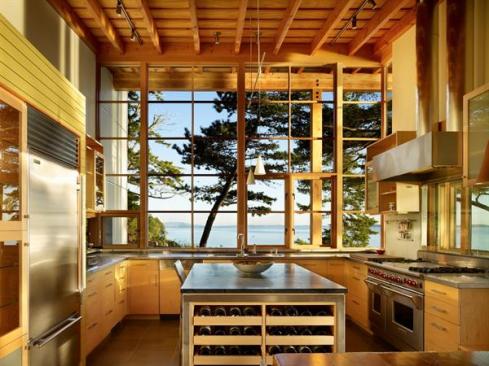 The kitchen feels expansive, thanks to well placed windows and a warm, modern material palette. 