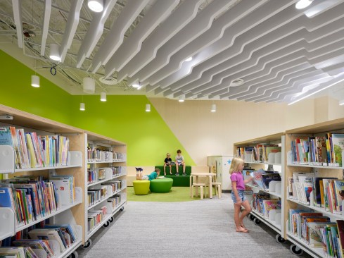 Bright pops of color and a mix of soft and hard furniture are invitations to hang out in the kid zone. We created custom designed acoustic ceiling baffles that provide interest and dampen sound.