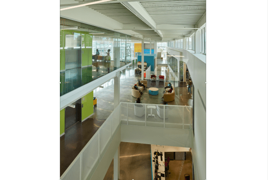 A floating Teen Loft, combined with light wells, creates a suspension of disbelief accentuated by bridges, layering of planes and floating objects. Openings visually connect adults with teens, while bringing natural light down from clerestories above to the entrance level below. All stairs and entrance/exit doors are in line of sight from the circulation desk.  
