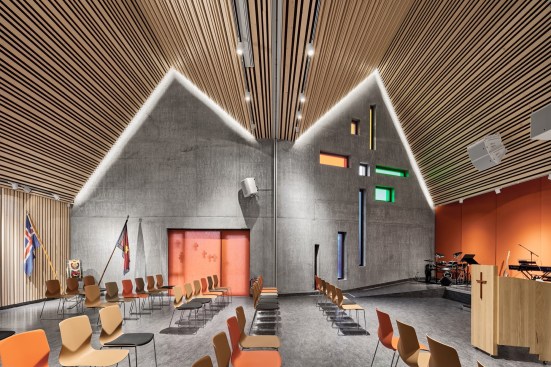 The building is clad with fibre cement sheets of varying shades of red