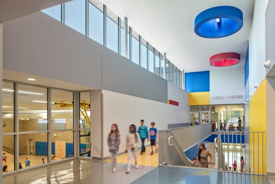 Inserted a double height space where a single-story double loaded corridor previously was. Energized the corridor through color, transparency, and natural daylight.
