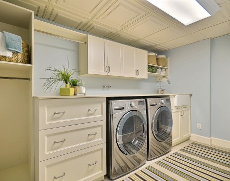 The decorative ceiling and clean, contemporary lines add a touch of class where it is least expected: the laundry room.  
