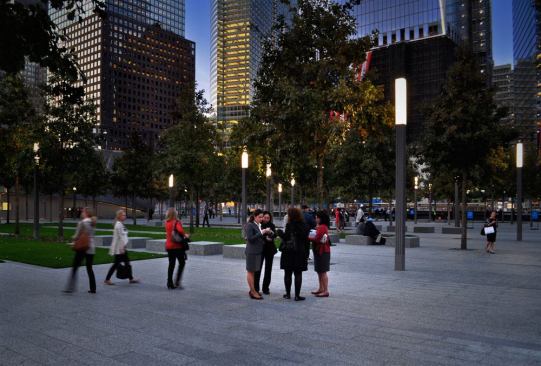 The landscape design includes more than 400 white oak trees across the site. Square light columns, each standing just over 16 feet tall, incorporate security cameras and radio antennas along with the lighting element at the top: prismatic refractors with four 4-foot-long T8 lamps.