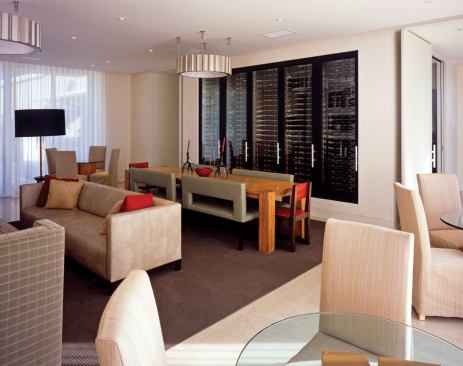 A large wine refrigerator separates the living room and kitchen.