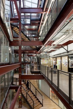 Responding+to+the+central+concentration+of+tiles+on+the+main+facade%2c+a+new+four-story+central+atrium+provides+daylight+and+orientation.