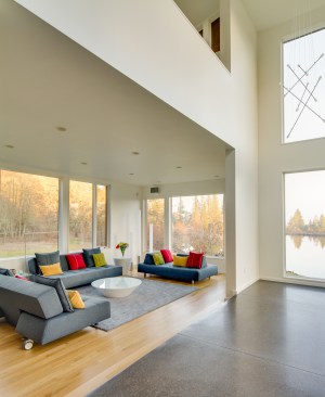 Ample windows bring in light and frame stunning views of the serene lake, distant mountains, and nearby woods. The kitchen is in the heart of the house and is adjacent to the open-plan family / music room that overlooks the pond