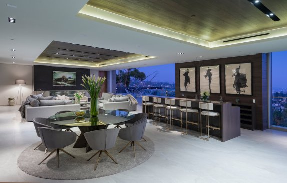 Sliding glass walls open up the modern kitchen to jetliner views at the Los Tilos Hollywood Hills home.
