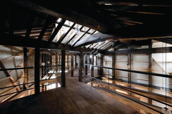 Rotated in relation to each other, the timber frames form a geometrically complex interior.