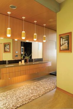 The master bath’s washing area occupies a linear space that angles away from the rest of the house’s floor plan, aligning two contrasting outdoor views.
