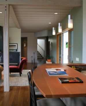 The house framing and ceiling beams are all made of glulam. The support to the left is resawn, whitewashed glulam. Floors are engineered walnut.