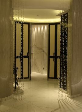 In the changing areas, curtains of glass beads  create another layer of texture and pattern. Tiny LED spots at each locker come  on when the door is opened.