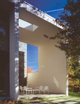 Architect David Jameson made a compact, efficient floor plan seem more spacious by injecting a shot of vertical volume into both the living room and the covered patio.