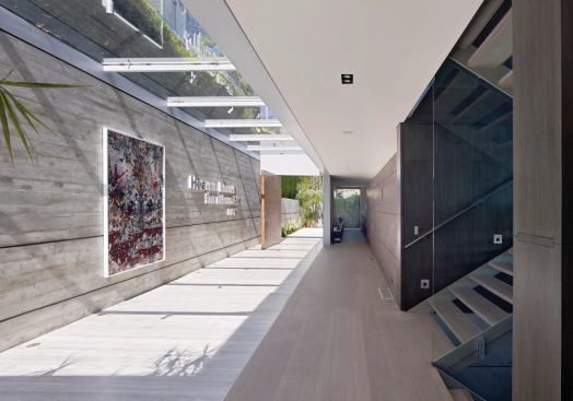 Another view of the sunlit entry foyer, which creates a pleasing confusion between indoors and out.
