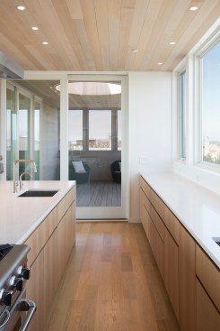 Off the kitchen, a screened, covered porch has an oculus roof opening