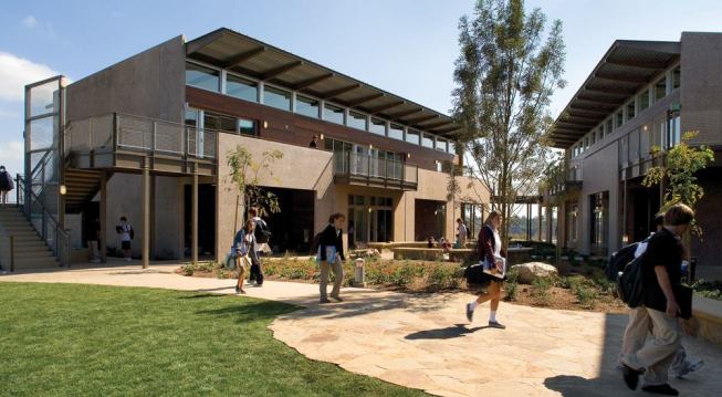 The two-story upper school classroom buildings have structures of concrete colored with locally sourced aggregates. Cantilevered sunshades protect the second floor walkways from periodic rainfall.