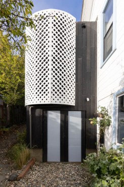 Master shower privacy is afforded by perforated aluminum panels.