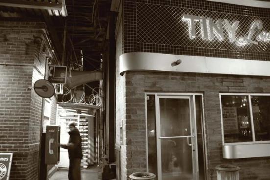 The original Tiny Lounge was an alternative to the neighborhood bar on Chicago?s North Side. With it?s brick fa?ade and retro signage, the hot spot evoked a Rat Pack feel while offering both perfectly mixed cocktails and an after-work alternative for the people in the area.