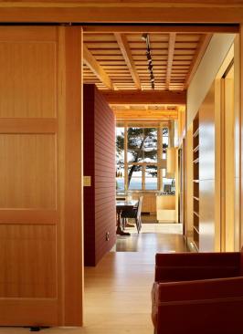 The well choreographed view from the den through the dining room and kitchen. 