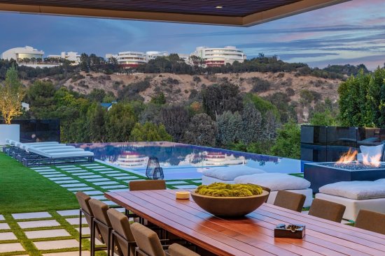 Modern luxury Los Angeles home outdoor poolside terrace dining room.