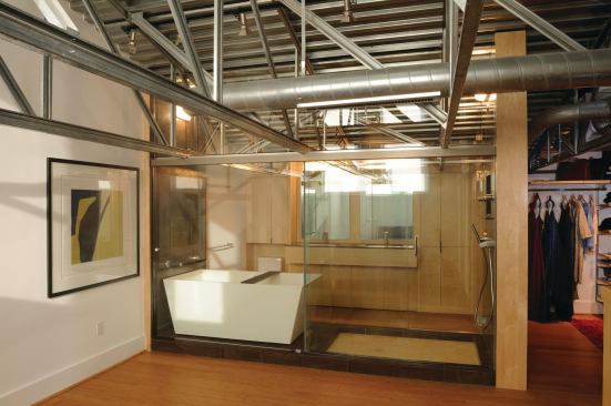 Staying true to the loft aesthetic, architect Steven Spurlock’s pared-down design allowed for only what was necessary, leaving a dramatic exposed roof structure, warmed by maple casework. Project: Loft Conversion, Washington, D.C.; Builder: CMG, Inc., Washington; Architect: Wnuk Spurlock Architecture, Washington