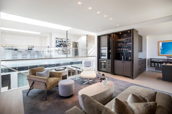 Living room, home office and wet bar in open plan Beverly Hills home.