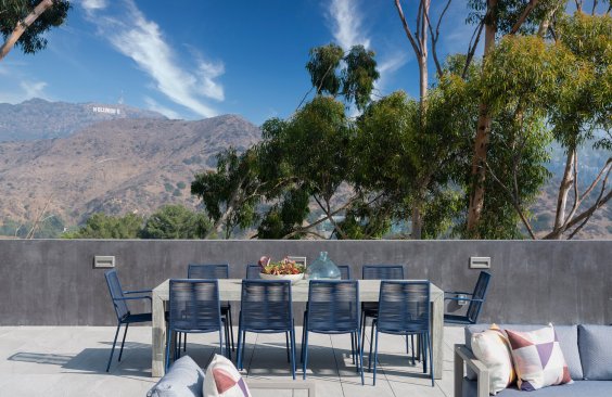 Los Tilos modern home poolside terrace fire pit with seating area.
