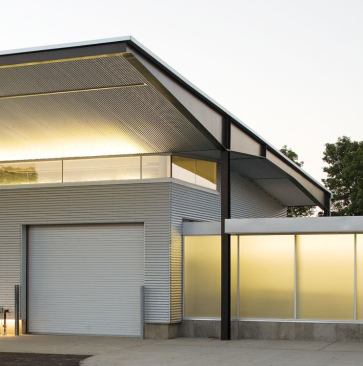 At the clerestory, 4-foot T5HO lamps uplight the underside of the Galvalume roof.