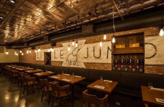 Much of the 1920’s ambience of Little Jumbo restaurant is created with modern materials, including the wall of “exposed” brick that is actually an added veneer with a carefully aged-looking painted logo, and the ceiling that is made, not of old stamped metal, but new Ceilume thermoformed tiles.