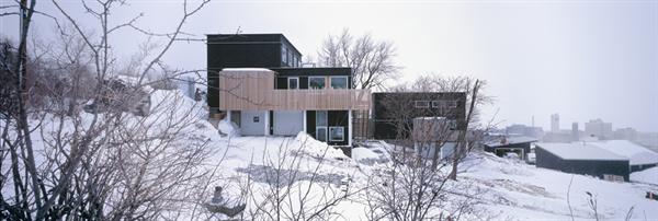 The black siding, used as a skateboard surface in parks, is made of recycled paper and resin.