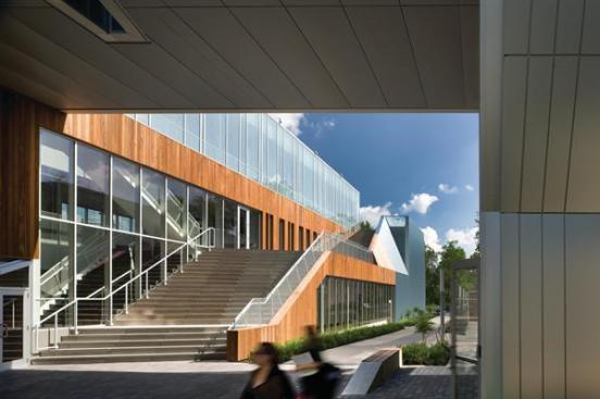 Sustainably harvested ipe is used as part of the LEED Gold strategy. It will weather to gray, relating in tone to the metal panels. The building's top floor is a fully glazed box that floats over Kohl plaza on the buildings west face. A custom frit pattern helps increase the glazings shading coefficent to 0.28 while adding another shade of gray to the palette. Over time, The building will become a series of gray tones as a backdrop for a vibrant art, Kurtz says.