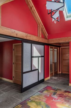 The entry shown here  incorporates features that evoke a Japanese influence, from the color tones chosen to design details, like handcrafted Shoji screens.