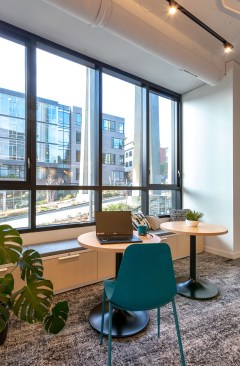 The open office area features felt acoustic baffles. 