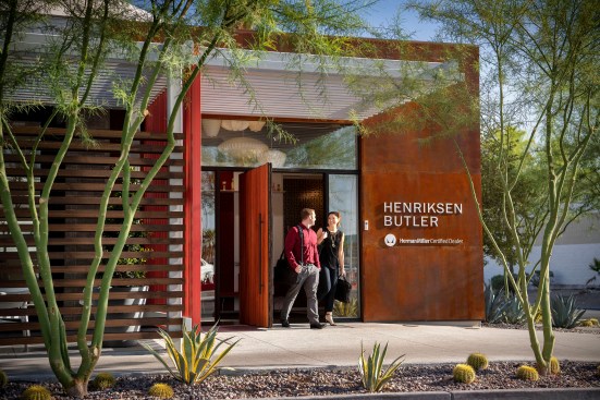 Native sculptural landscape, rhythmically placed, softens the building edges and helps filter views into the interior showroom space.
