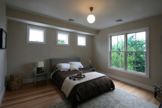 FSC-certified Plyboo bamboo flooring is produced from rapidly renewable grasses. High windows let in light while preserving privacy in the bedroom.