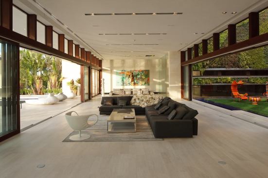 The house was conceived as a series of pavilions connected by outdoor spaces, gardens, and courtyards. Mocha Creme limestone planks in various lengths are used throughout the home.