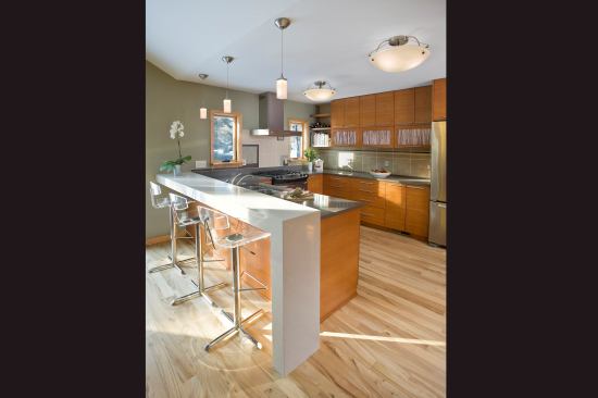 A dual-height peninsula accommodates seating, lets guests be close to the kitchen, and hides kitchen chaos from the living area. Project: Rautio, Mounds View, Minn.; Designer/Builder: Otogawa-Anschel Design Build