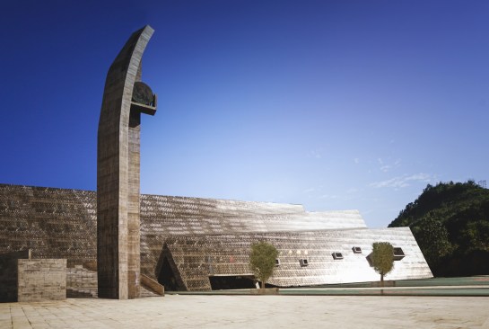 The bronze perforated skin shines under the sun 