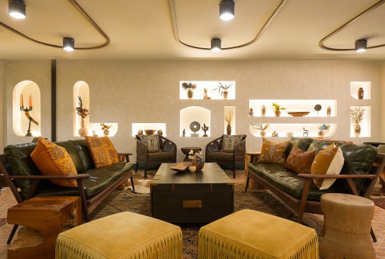 Eclectic furniture, curated from authentic vintage antique dealers, populates the space, with terracotta incorporated in both the overhead light fixtures and floor tiling. Wall cut-outs provide a respectful, indigenous-inspired means of presenting curated accessories that reinforce the space’s aesthetic.