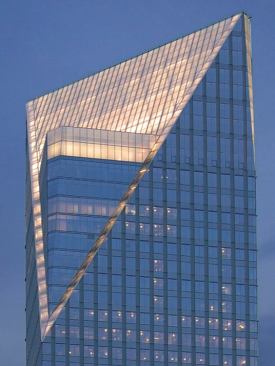The building is sliced off to reveal an inner tower that protrudes through the cut. To highlight this effect, the lighting designers only illuminated the surface of the slice itself-the large sloping plane that transition to lines of glass framing the inner core structure. Illumination of the top floor of the protruding tower core with 3000K fluorescents heightens the effect of the volume pushing through the slice. A warmer color consistency is maintained throughout.