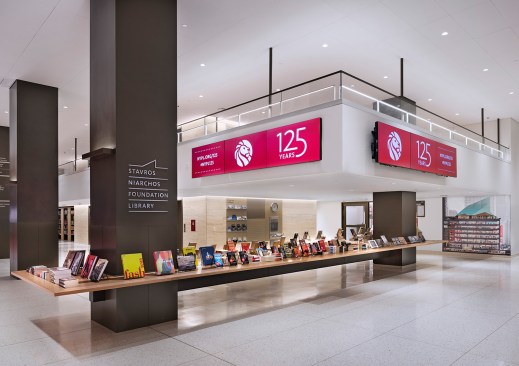 Located on one side are elevators, stairs, and a mezzanine balcony.
