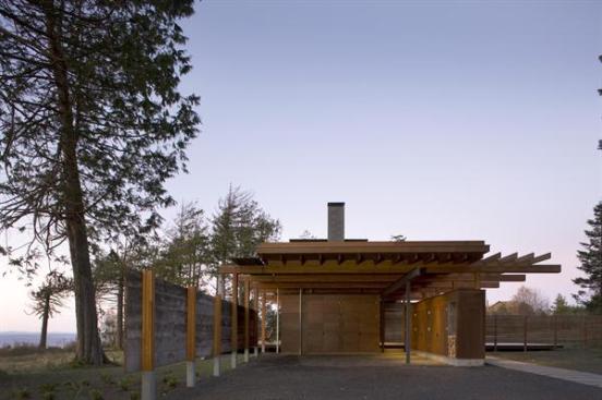 A roof over the carport and corridor is planted with native grasses, reducing runoff and heat gain. All rainwater is either captured for irrigation use or dispersed on-site.