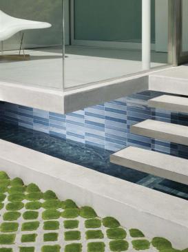 The sequence begins with a strip of moss-filled permeable pavers, followed by stairs floating above moving water. 