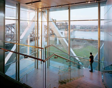 Extensive glazing allows daylight to reach interior spaces, while providing views toward the Arkansas River and the surrounding park.