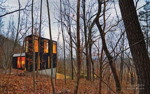 Stacked Cabin  Award of Merit 
Johnsen Schmaling Architects 
Stacked Cabin sits on a wooded, sloped site at the end of an old logging road in rural southwest Wisconsin. Rather than incorporating the open floor plan typical of regional cabin design, however, the architects stacked the spaces (living space, bathroom, toolshed) to minimize the building’s physical footprint. The bottom level supports the first floor, which includes an open living room, galley kitchen, and small bedrooms separated by movable curtains. Large windows can be transformed into screened openings, making the living space an outdoor room in the summer.